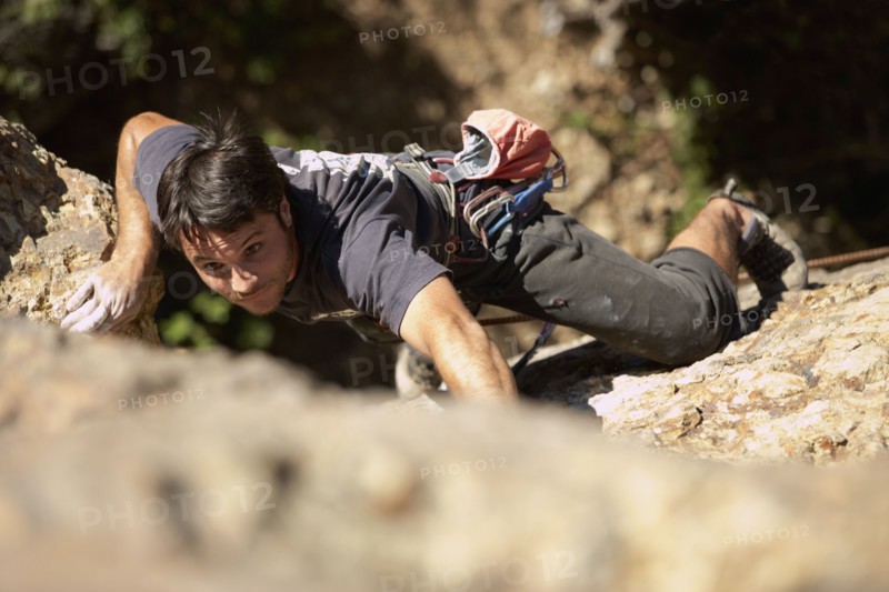 Argentinean man rock climbing