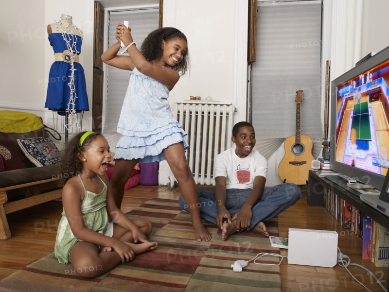 Sisters playing video games in living room