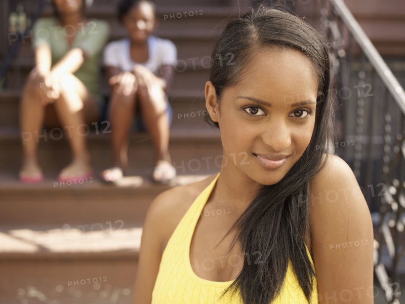 Smiling African woman with family in background