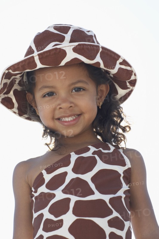 Young mixed race girl in bathing suit and hat