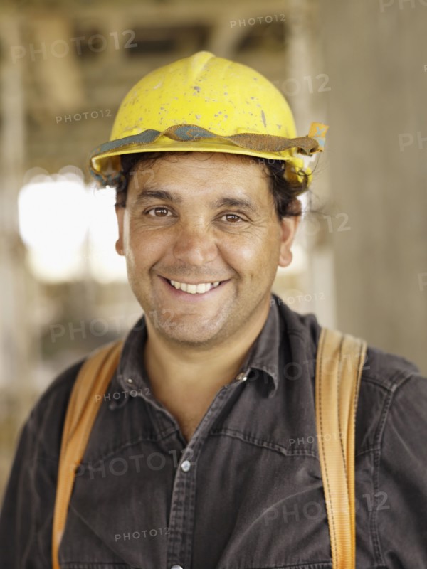 Hispanic worker smiling on construction site
