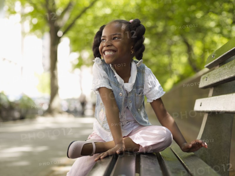 African girl smiling on bench