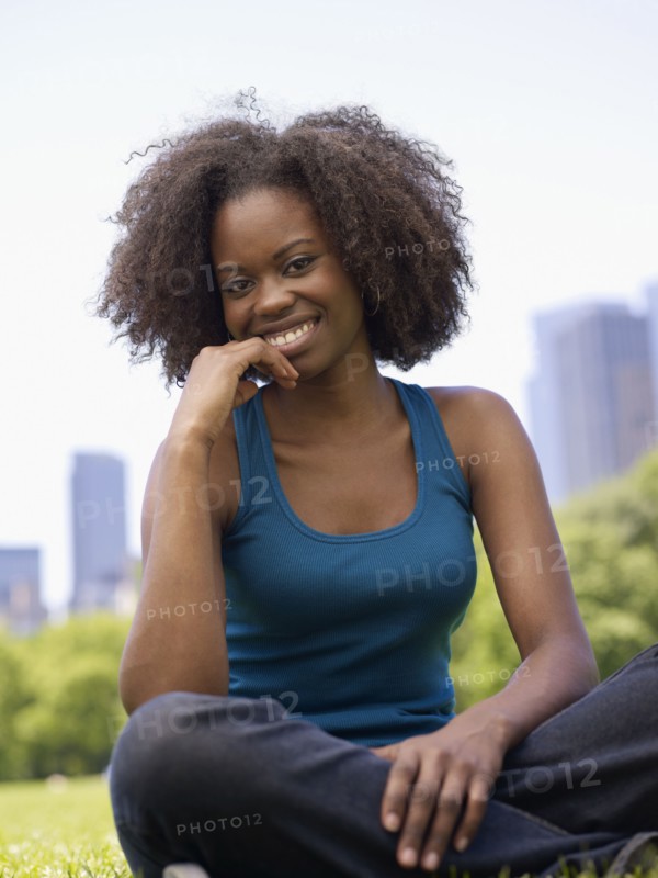 African woman smiling in park