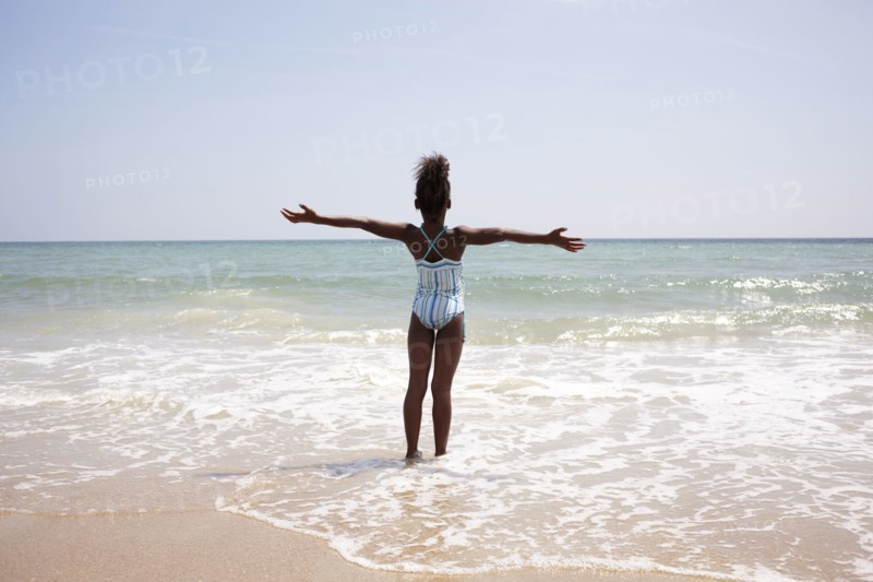 Jamaican girl wading on beach