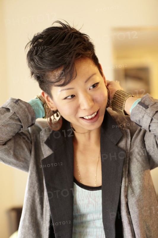 Smiling Korean woman dressing