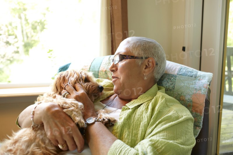 Caucasian woman holding dog