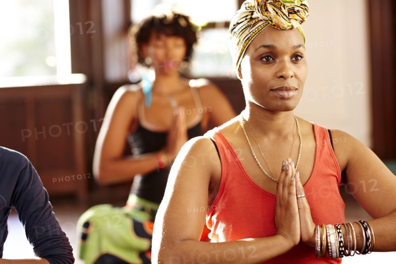 Woman meditating in yoga class
