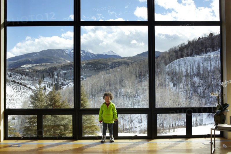 Mixed race girl standing in ski lodge