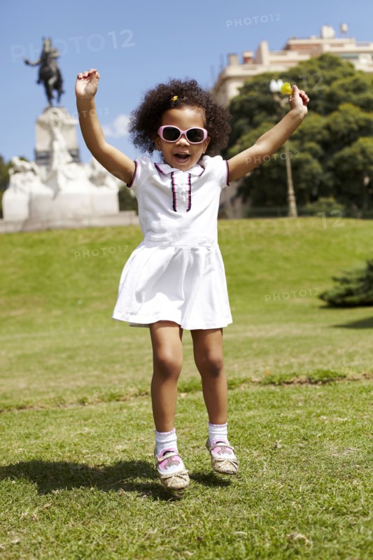 Mixed race girl playing in park