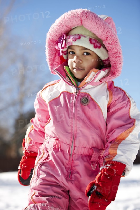 Mixed race girl wearing snowsuit