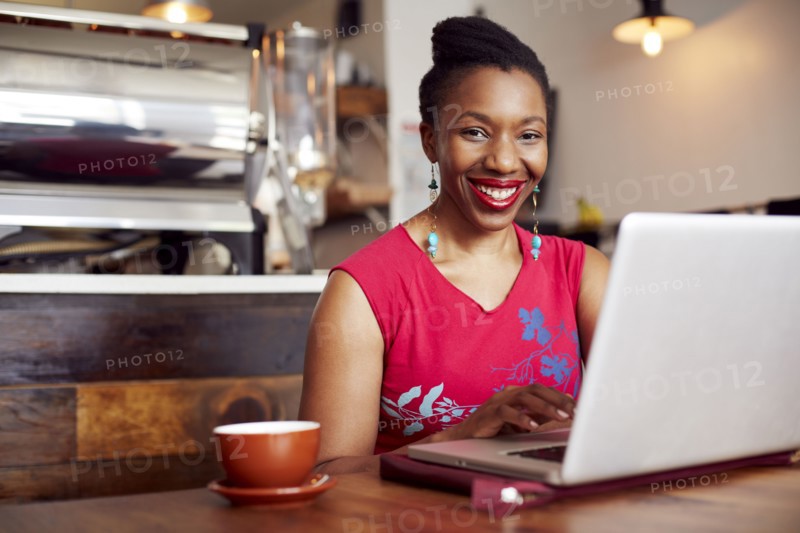 Woman using laptop in cafe