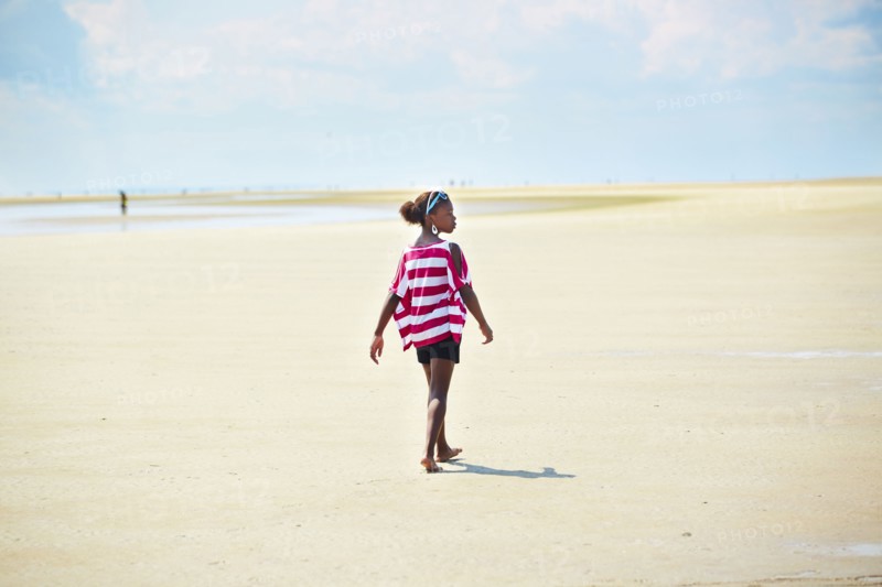 Black girl walking on beach