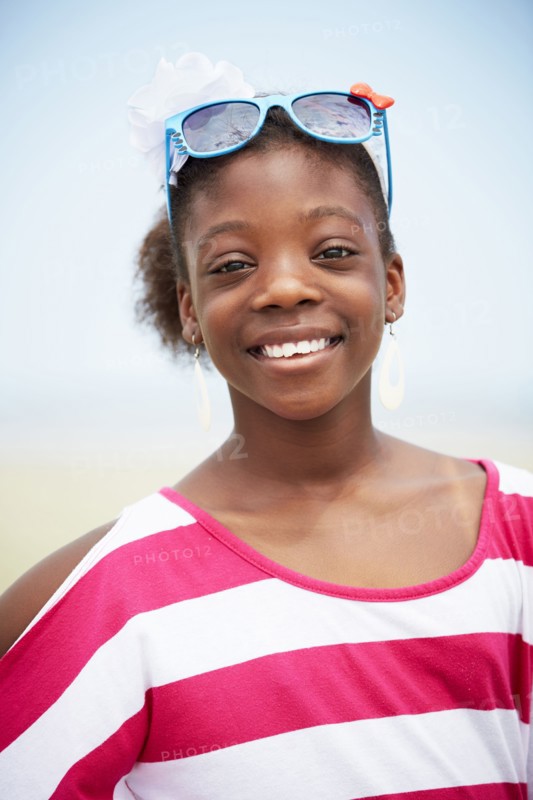 Black girl wearing novelty sunglasses outdoors
