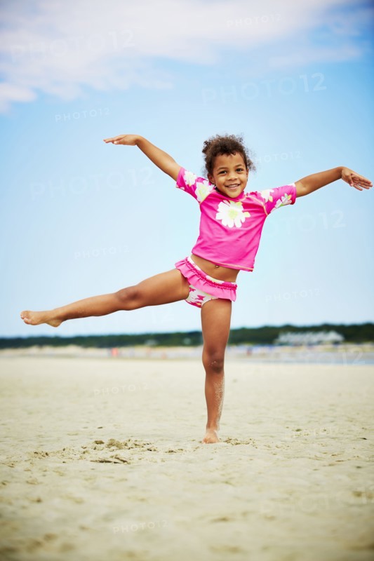 Mixed race girl posing on beach