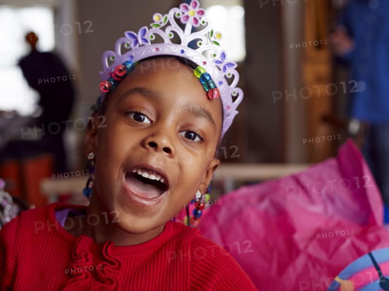 Black girl wearing tiara at party