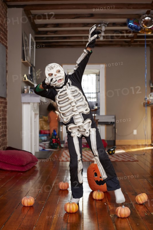 Black boy wearing skeleton Halloween costume