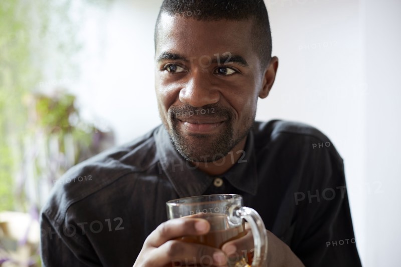 Black man drinking cup of tea