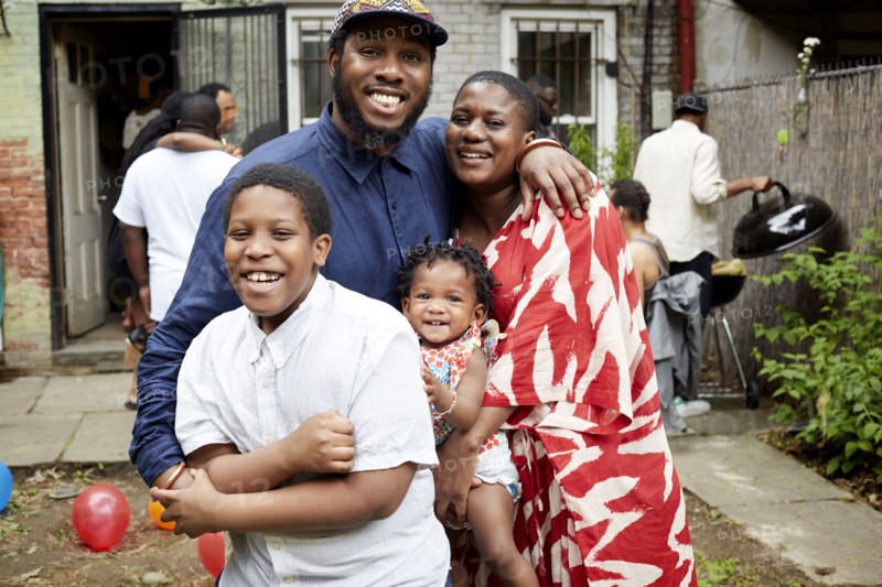 Family hugging at backyard barbecue