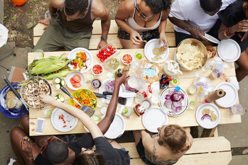 High angle view of friends enjoying backyard barbecue