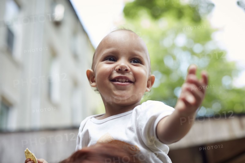Mixed race baby boy smiling outdoors