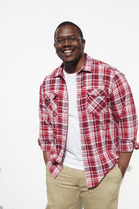 Black man standing with hands in pockets