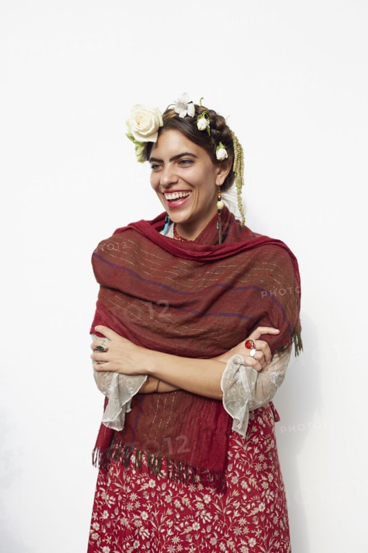 Stylish woman wearing shawl and flowers in hair