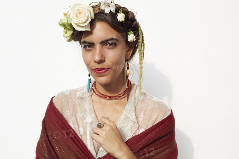 Stylish woman wearing shawl and flowers in hair