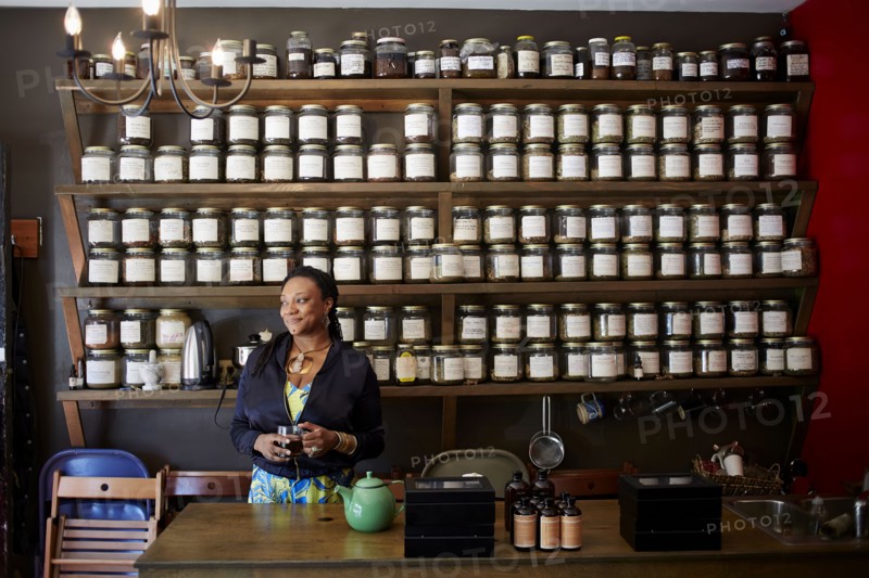 Black woman drinking tea in tea shop