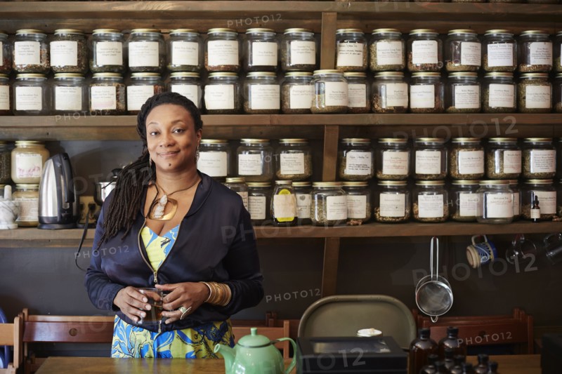 Black woman drinking tea in tea shop