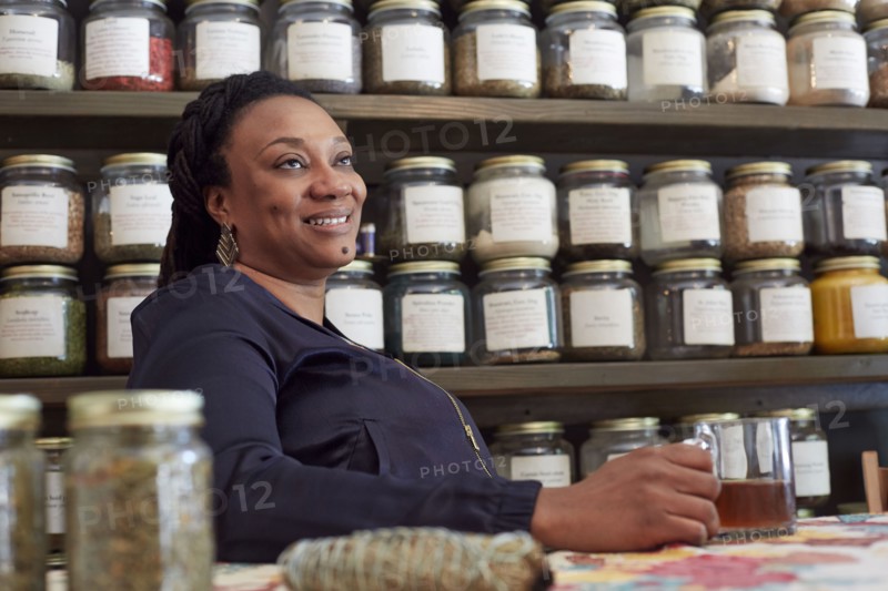 Black woman drinking tea in tea shop