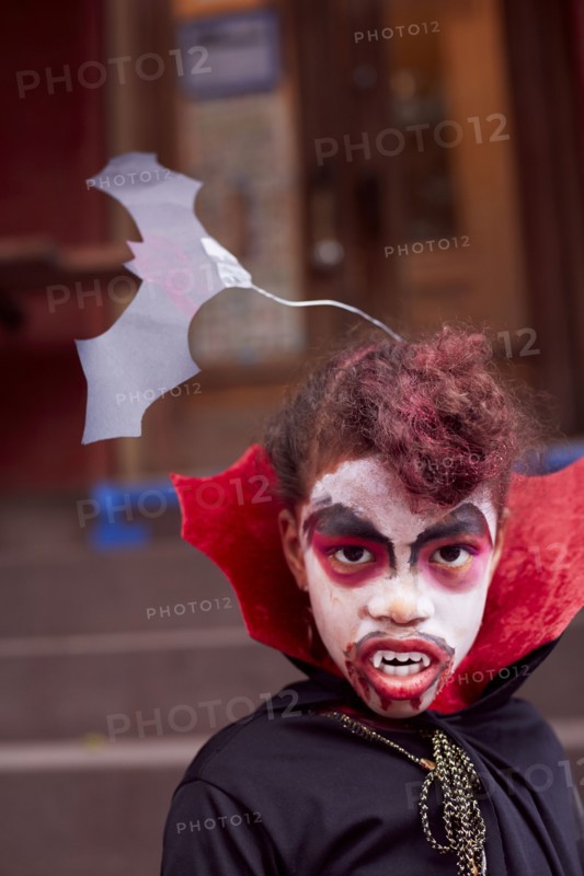 Mixed race girl wearing vampire costume