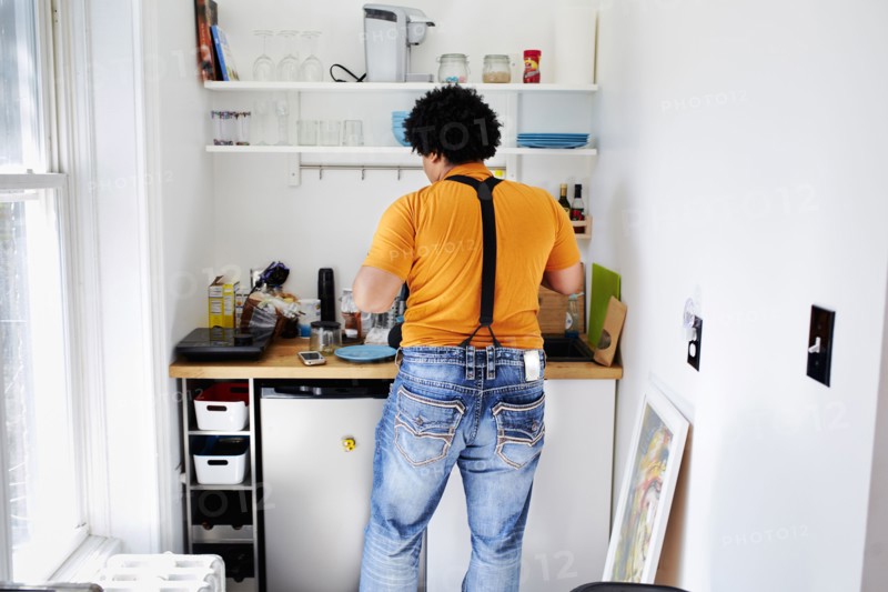 Mixed race man cooking in kitchen
