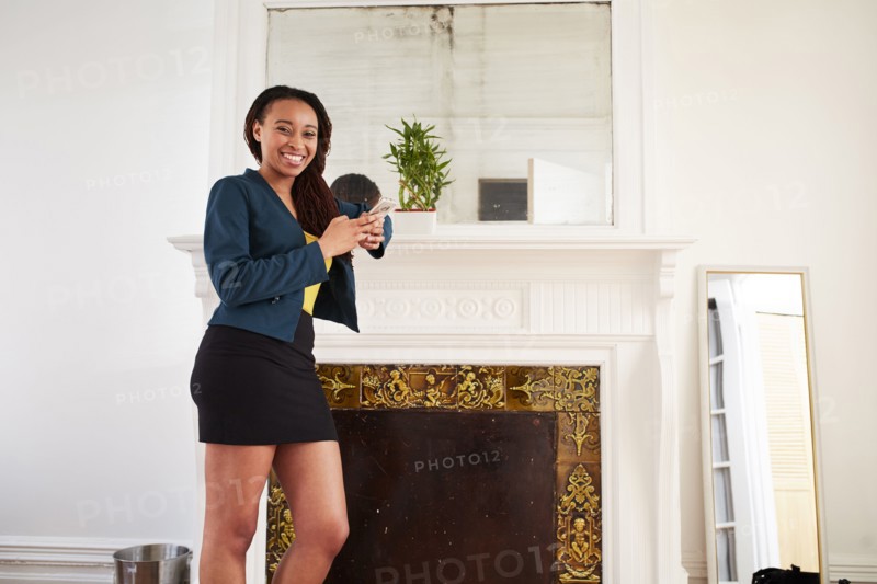 African American woman smiling near fireplace