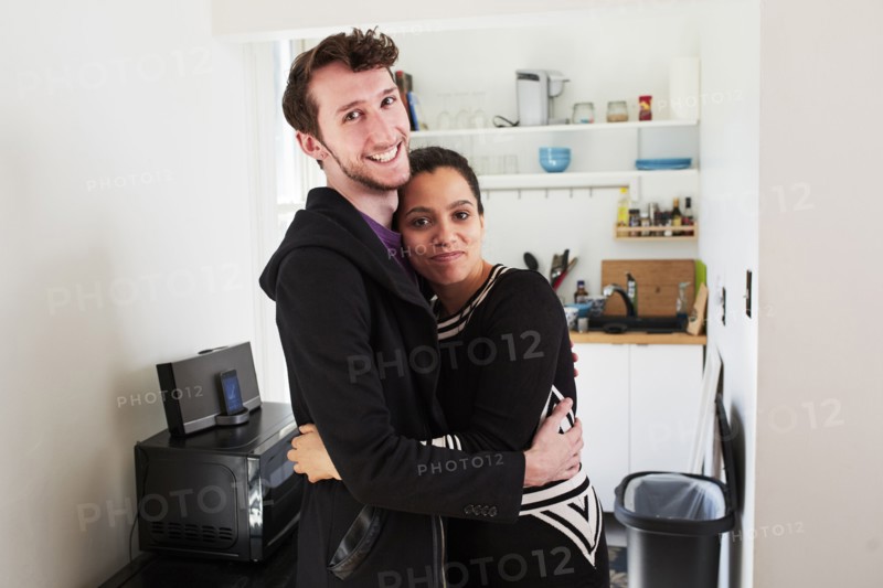 Couple hugging in kitchen