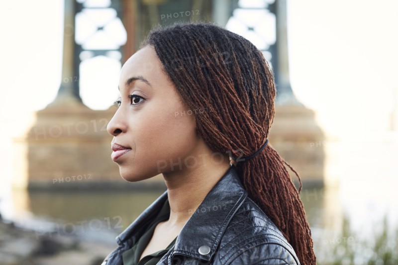 Profile of serious Black woman at bridge