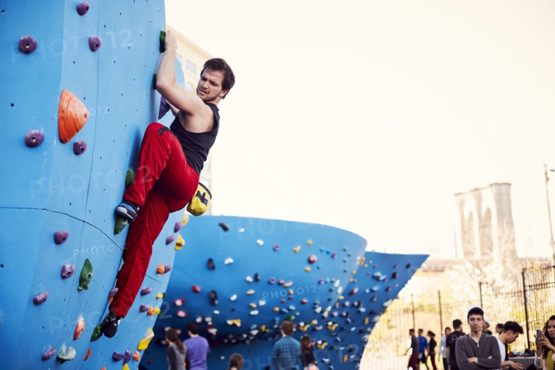 Caucasian man climbing outdoor climbing wall