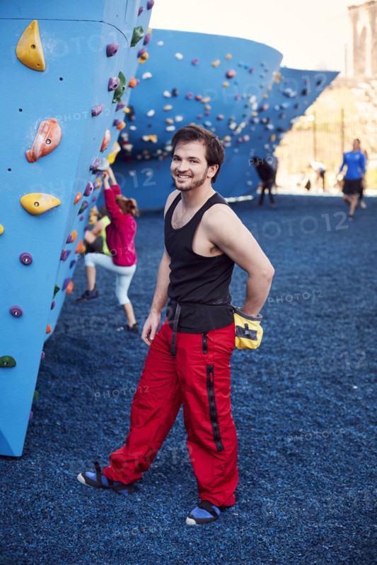 Caucasian man posing at outdoor climbing wall
