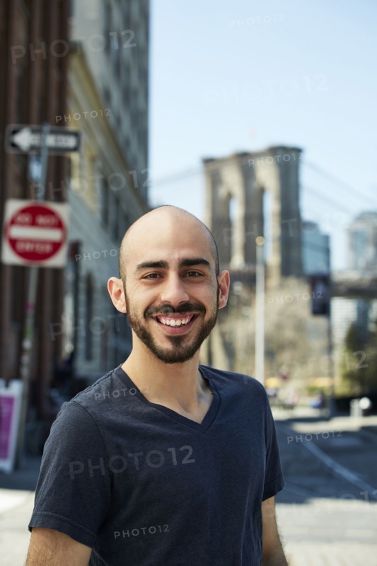 Smiling Hispanic man in city