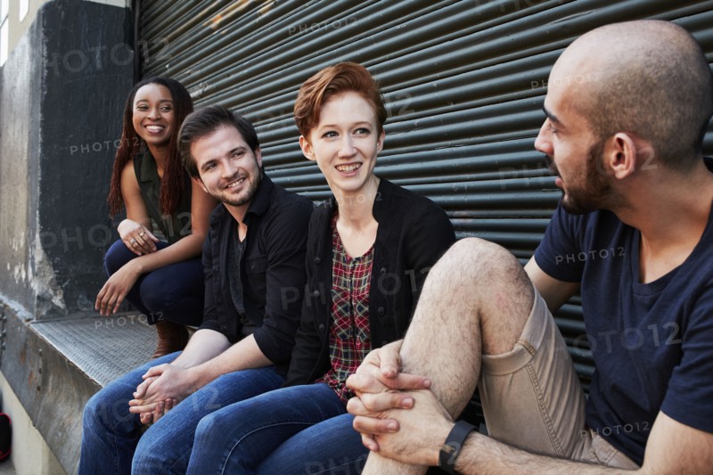 Friends talking on loading dock
