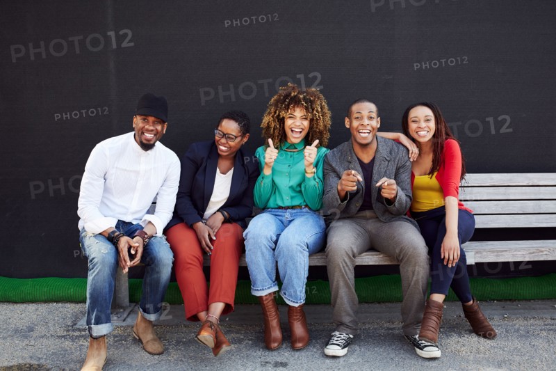 Laughing friends posing on bench