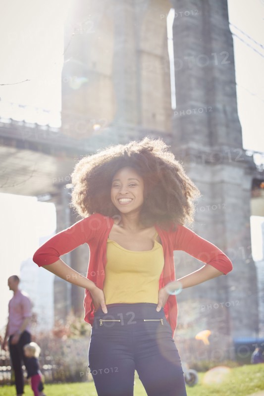 Smiling Black woman posing with hands on hips