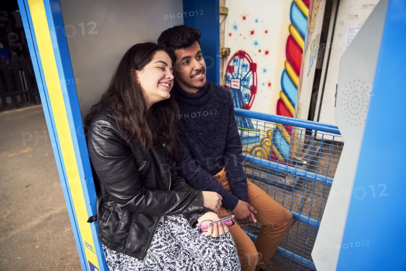 Couple posing in photo booth at amusement park