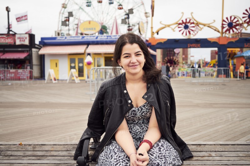 Mixed Race woman sitting on bench at amusement park
