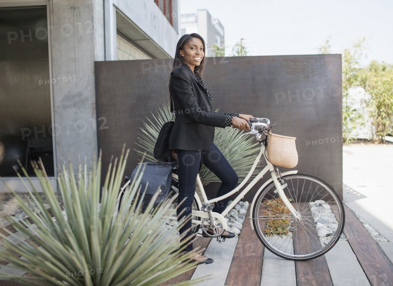 Woman standing with bicycle