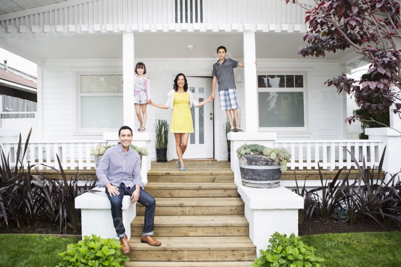 Family smiling together on porch