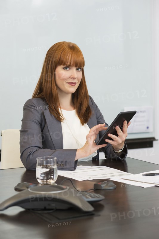 Caucasian businesswoman using digital tablet in office