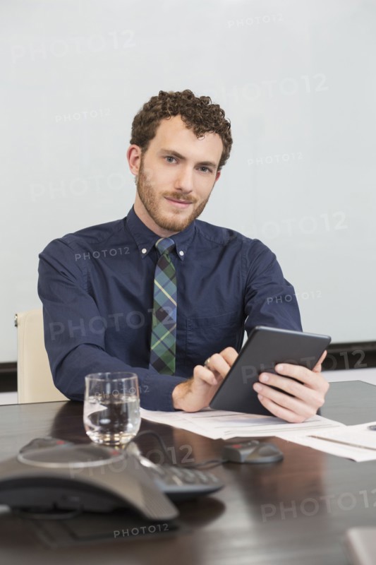 Caucasian businessman using digital tablet in office