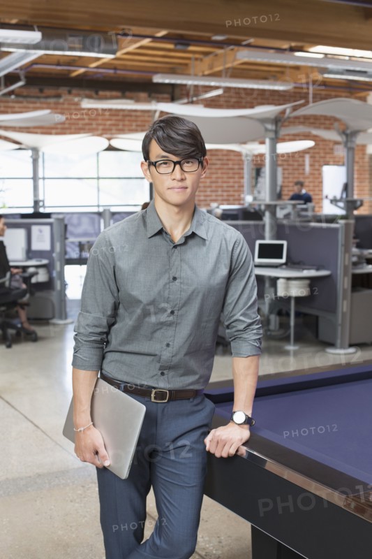 Businessman standing in office lounge area