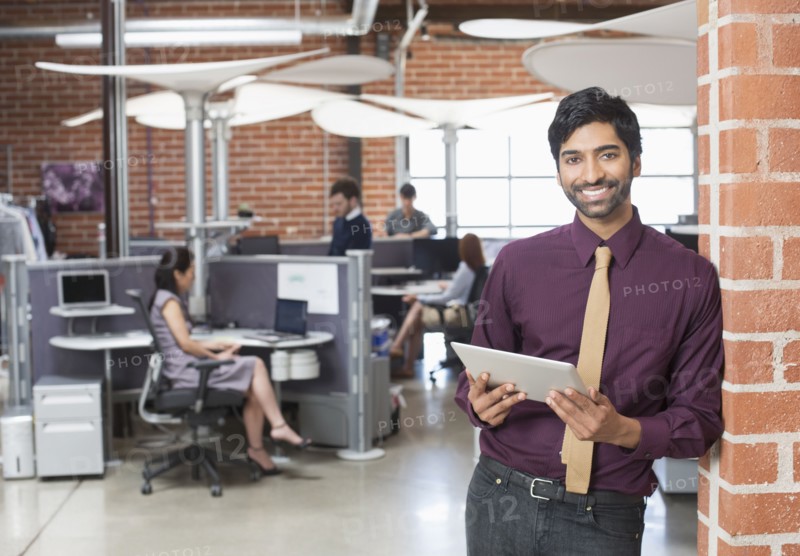 Businessman holding digital tablet in office