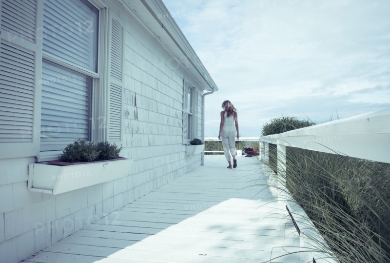 Caucasian woman walking on porch
